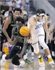  ?? Marcio Jose Sanchez Associated Press ?? UCLA GUARD Jaime Jaquez Jr., right, steals the ball from Sacramento State forward Akol Mawein during the Bruins’ season opener at Pauley Pavilion.