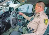  ?? DANIEL PEARSON/THE TAOS NEWS ?? Taos County Sheriff’s Deputy Mike Holley shows a vehicle equipped with surveillan­ce technology.