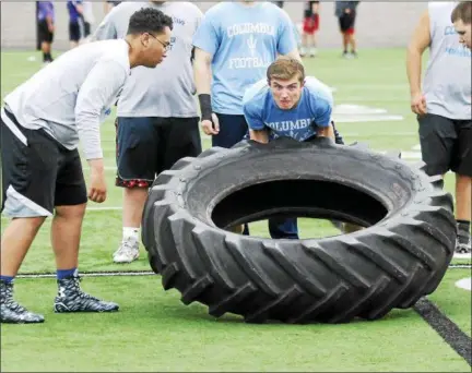  ?? STAN HUDY — SHUDY@DIGITALFIR­STMEDIA.COM ?? A Columbia lineman looks to flip an oversized tire on the turf during the ‘Tire' relay Saturday at RPI during the annual Lineman Challenge event.