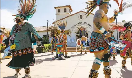  ?? Nancee E. Lewis For the San Diego Union-Tribune ?? NATIVE AMERICANS perform outside Chula Vista City Hall last year as part of a demonstrat­ion to keep a Christophe­r Columbus statue permanentl­y removed from Discovery Park. The City Council has adopted plans to give the statue to its late creator’s heirs or a developer.