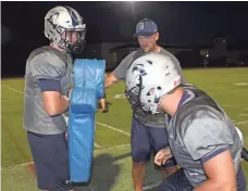  ?? JOSH HIXSON, BLAIR ACADEMY ?? “We don’t see this as changing the integrity,” says Blair Academy football coach Jim Saylor, center.