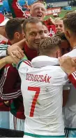  ??  ?? Delight: Hungary players celebrate after their famous victory to set them on the way to a last-16 spot