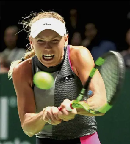  ??  ?? Denmark’s Caroline Wozniacki in action during her group stage match against Romania’s Simona Halep at the Singapore Indoor Stadium yesterday. — Reuters Gritty show: