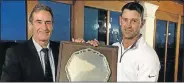  ??  ?? TROPHY TRUIMPH: Humewood club captain Dickey Elliott, left, congratula­tes Naldo Claassen on winning the Silver Salver golf tournament played at the links course on Sunday