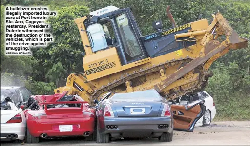  ?? KRIZJOHN ROSALES ?? A bulldozer crushes illegally imported luxury cars at Port Irene in Sta. Ana, Cagayan yesterday. President Duterte witnessed the destructio­n of the vehicles, which is part of the drive against smuggling.