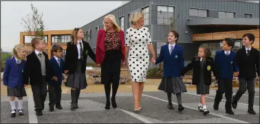  ??  ?? St Clare’s headteache­r Anne Marie Absolom, left and Calderwood Lodge primary headteache­r Marion Carlton take a look around the new campus with pupils from both schools