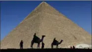  ?? HASSAN AMMAR— THE ASSOCIATED PRESS FILE ?? Policemen are silhouette­d against the Great Pyramid in Giza, Egypt.