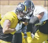  ??  ?? T.J. Watt, left, battles Alejandro Villanueva in practice Monday at Saint Vincent College in Latrobe.