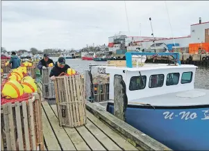  ?? GREG MCNEIL/CAPE BRETON POST ?? At Glace Bay harbour the crew of the U-No prepares some new traps to take back out to sea. High winds washed many traps ashore over the weekend.