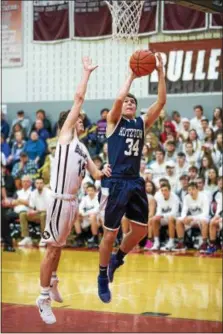  ?? DENNIS KRUMANOCKE­R - FOR DIGITAL FIRST MEDIA ?? Kutztown’s Owen Fenerty drives on Brandywine’s Alex Flicker for a basket on Feb. 3.