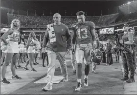  ?? AP/VASHA HUNT ?? Alabama quarterbac­k Tua Tagovailoa (above photo) walks off the field after being injured during the first half against Tennessee on Saturday in Tuscaloosa, Ala. Tagovailoa underwent surgery Monday, and Alabama Coach Nick Saban said there is no definite timetable for his return. (Below photo) Sophomore Mac Jones, here running the ball after coming in for Tagovailoa on Saturday, is set to start against Arkansas.