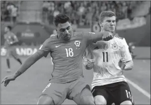  ?? The Associated Press ?? ROUGH PLAY: Chile’s Gonzalo Jara fouls Germany’s Timo Werner, right, during the Confederat­ions Cup final between Chile and Germany, at the St. Petersburg Stadium, Russia, Sunday.