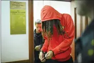  ?? ALEXANDER ZEMLIANICH­ENKO — THE ASSOCIATED PRESS ?? WNBA star and two-time Olympic gold medalist Brittney Griner leaves a courtroom after a hearing, in Khimki just outside Moscow, Russia, Friday, May 13, 2022. Griner, a two-time Olympic gold medalist, was detained at the Moscow airport in February after vape cartridges containing oil derived from cannabis were allegedly found in her luggage, which could carry a maximum penalty of 10 years in prison.