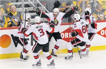  ?? AP ?? The Senators’ Bobby Ryan, centre, celebrates his match-winning goal against the Penguins with teammates.