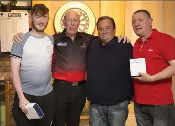  ??  ?? Division 2 League winners Kyle Ryan, Charlie Byrne, Damian Douglas with darts profession­al John Lowe at the Wicklow Darts presentati­on night at the Woodpecker Ashford recently.