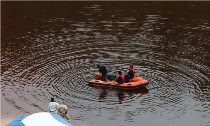  ??  ?? Officers search a lake for bodies near the village of Mitsero. Photograph: Yiannis Kourtoglou/Reuters