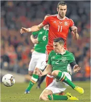  ??  ?? Seamus Coleman knocks the ball away from Wales’ Gareth Bale in Friday’s clash.