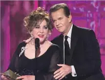  ?? Chris Haston NBC ?? GOLDEN GLOBES: Dick Clark gives a tipsy Elizabeth Taylor a hand during her presentati­on of the best picture winner in 2001.