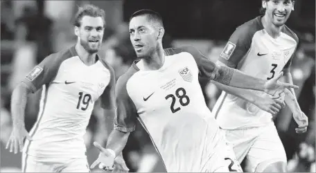  ?? Jeffrey McWhorter Associated Press ?? CLINT DEMPSEY, center, celebrates with teammates Graham Zusi, left, and Omar Gonzalez after scoring a goal Saturday against Costa Rica. Dempsey is one of a number of U.S. players who have parlayed a strong Gold Cup showing into a place on the World Cup...