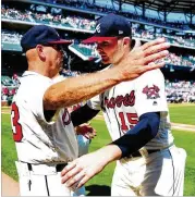  ?? SCOTT CUNNINGHAM/GETTY IMAGES ?? Sean Newcomb (right) gets congratula­tions from manager Brian Snitker after barely missing a no-hitter Sunday. TODAY’S GAME Marlins at Braves, 7:35 p.m., FSSE, 680, 93.7, 106.7