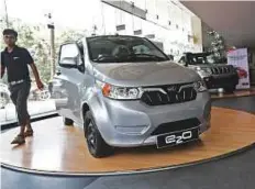  ?? Reuters ?? A Mahindra e2o electric car on display at a showroom in Mumbai. India unveiled a policy blueprint this month aimed at electrifyi­ng all vehicles in the country by 2032.