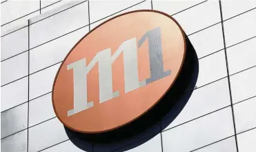  ?? — Reuters ?? Valued asset: An M1 logo is pictured outside their office in Singapore. Axiata, which has a 28.3% stake in M1, views the Keppel-led offer of S$2.06 per M1 share as opportunis­tic and inadequate.