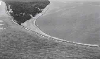  ?? WINDSOR STAR ?? An aerial view of the long sandy tip of Point Pelee National Park in 1956. Last year, as Canada celebrated its 150th anniversar­y with free passes, Point Pelee’s attendance skyrockete­d to about 535,000 visitors.