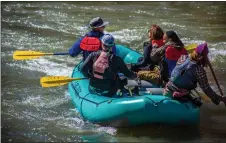  ?? NATHAN BURTON/Taos News ?? A raft guided by Los Rios River Runners navigates the Racecourse in early spring 2022.