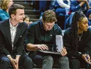  ?? UConn athletics/Contribute­d photo ?? UConn women’s basketball graduate assistant Jake Gallo (center) during the Huskies game against Jackson State Saturday.