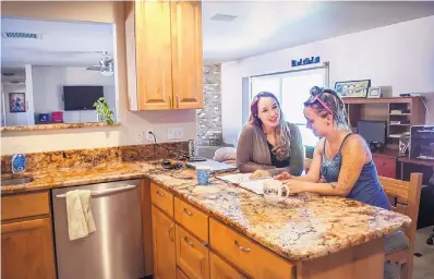  ?? DEAN HANSON/JOURNAL ?? Jeri Hollan, left, goes over the goals and progress being made by Lindsey Lepisto, a resident at Precious Gifts, a transition­al living home in Albuquerqu­e that helps women navigate a clean, independen­t and productive life after prison, jail or drug...