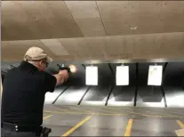  ?? GINGER RAE DUNBAR – MEDIANEWS GROUP ?? Downingtow­n police Officer Kevin Coyle, who is a firearms instructor, participat­es in the Pistol Match portion of the competitio­n held at the Chester County Public Safety Training Campus.