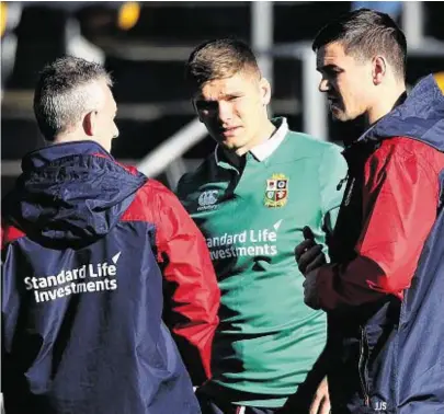  ??  ?? LIONS PAIR OF ACES: Owen Farrell and Johnny Sexton, right, talk to backs coach Rob Howley, left