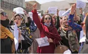  ?? — AP ?? Women gather to demand their rights under Taliban rule during a protest in Kabul on Friday. As the world watches intently for clues on how the Taliban will govern, their treatment of the media will be a key indicator, along with their policies toward women.