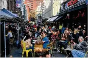  ?? ALBERTO PEZZALI / AP ?? People sit, drinking and eating, outside cafes and pubs Soho, central London, Monday as some of England’s lockdown restrictio­ns were eased.