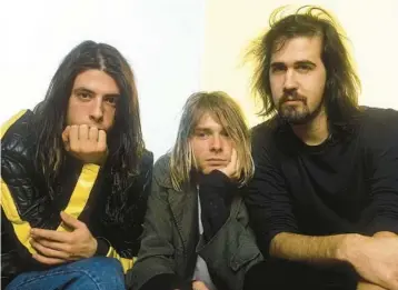  ?? AJ BARRATT/UPPA 1992 ?? Drummer Dave Grohl, from left, singer and guitarist Kurt Cobain and bassist Krist Novoselic of Nirvana.