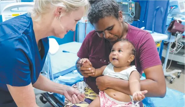  ?? ?? Dr Donna Franklin performs a check-up on Lily York’s seven-month old daughter Jenovia York-Charger. Picture: Supplied