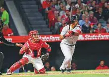  ?? USA Today Sports ?? Boston Red Sox third baseman Rafael Devers hits a grand slam home run against the Los Angeles Angels in the third inning at Angel Stadium of Anaheim.