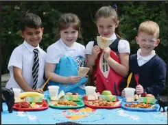  ??  ?? St Monica’s Primary School pupils, from left, Daniel Burke, 5, Emma Flannagan, 6, Chloe Godfrey, 6, and Rocco Holmes, 5, try out the food