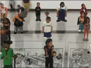  ??  ?? A collection of “Homies” figures designed by artist David Gonzales that are part of the exhibition on lowrider culture at the Dr. Martin Luther King Jr. Main Library.