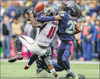  ?? OTTO GREULE JR. / GETTY IMAGES ?? Falcons wide receiver Julio Jones can’t make the catch on fourth down as Seahawks cornerback Richard Sherman grabs Jones’ left shoulder Oct. 16 in Seattle.