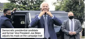  ??  ?? Democratic presidenti­al candidate and former Vice President Joe Biden adjusts his mask on the campaign trail