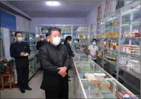  ?? (AP/Korean Central News Agency/Korea News Service) ?? In this photo provided by the North Korean government, North Korean leader Kim Jong Un (center) visits a pharmacy Sunday in Pyongyang, North Korea. Independen­t journalist­s were not given access to cover the event depicted in this image. The content of this image is as provided and cannot be independen­tly verified.