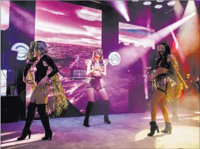  ?? Patrick Connollyz ?? Las Vegas Review-journal @Pconnpie Dancers perform Tuesday at a booth for ADJ lighting equipment during the Nightclub and Bar Show at the Las Vegas Convention Center. The show attracted more than 30,000 industry profession­als for three days of lectures...