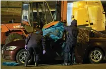  ??  ?? Hunt for clues: Specialist police officers search a BMW, believed to be Mr Skripal’s