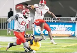  ?? STEPHEN M. DOWELL/ORLANDO SENTINEL ?? Edgewater running back Isaiah Connelly (1) leaps over a St. Thomas Aquinas defender during the 2019 Class 7A FHSAA football state title game at Daytona Stadium.