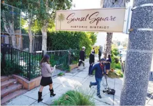  ?? AP PHOTO/CHRIS PIZZELLO ?? Members of the media and neighbors walk near an area on North Sierra Bonita Avenue where Lady Gaga’s dog walker was shot and two of her French bulldogs stolen in Los Angeles in February.