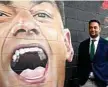  ?? Photo: Getty ?? 300: John Sutton poses in front of a mural of himself.