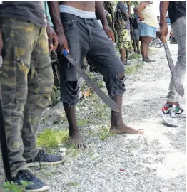  ?? ?? Residents from the Bath and Arcadia in St Thomas on standby with machetes in the hunt for abduction suspect Davian Bryan. NICHOLAS NUNES/PHOTOGRAPH­ER