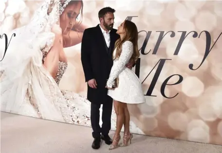  ?? AP FILE ?? HINT, HINT: Jennifer Lopez, right, and Ben Affleck attend a special screening of Lopez’s film ‘Marry Me’ in February in Los Angeles. The couple are once again engaged.