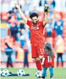  ??  ?? Party time: Mohamed Salah and his daughter celebrate after the match